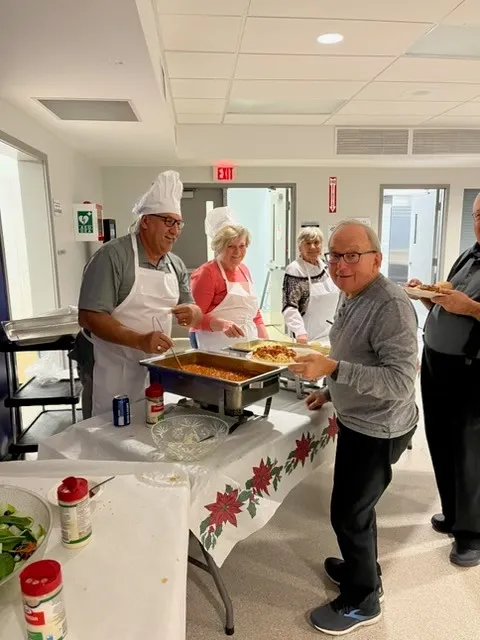Rick Champagne serving food at a community dinner in East Ferris