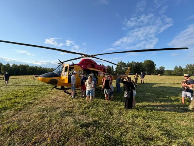 Residents gathered around a search and rescue helicopter in East Ferris
